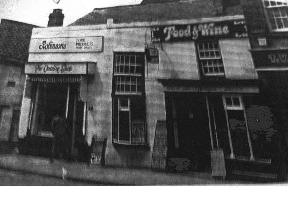 A black and white image of an existing business in the same place. The image is quite unclear to read what it says.